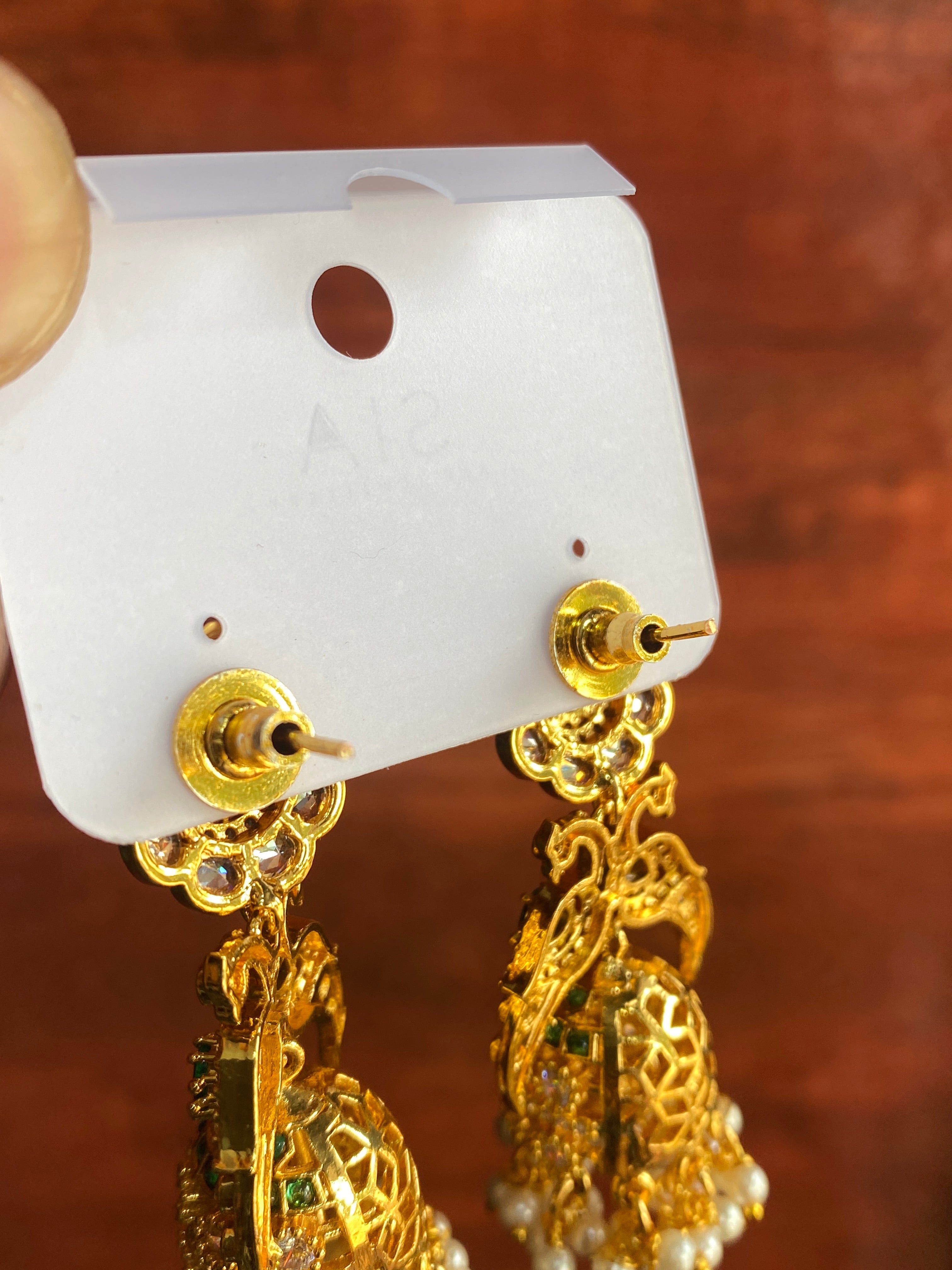 Royal Peacock Pearl Jhumka Earrings with American Diamonds & Green Stones | Gold-Plated Traditional Bridal Earrings for Women